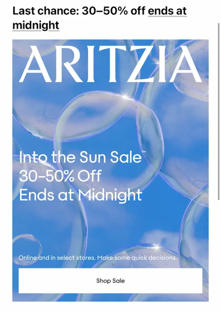 Aritzia “Into the Sun Sale” banner with a dreamy blue background filled with floating soap bubbles. Large text promotes 30–50% off, ending at midnight. Includes a “Shop Sale” button and note that the offer is available online and in select stores.