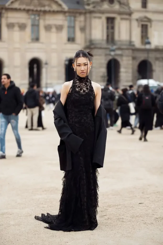 Woman in black lace gown and oversized blazer